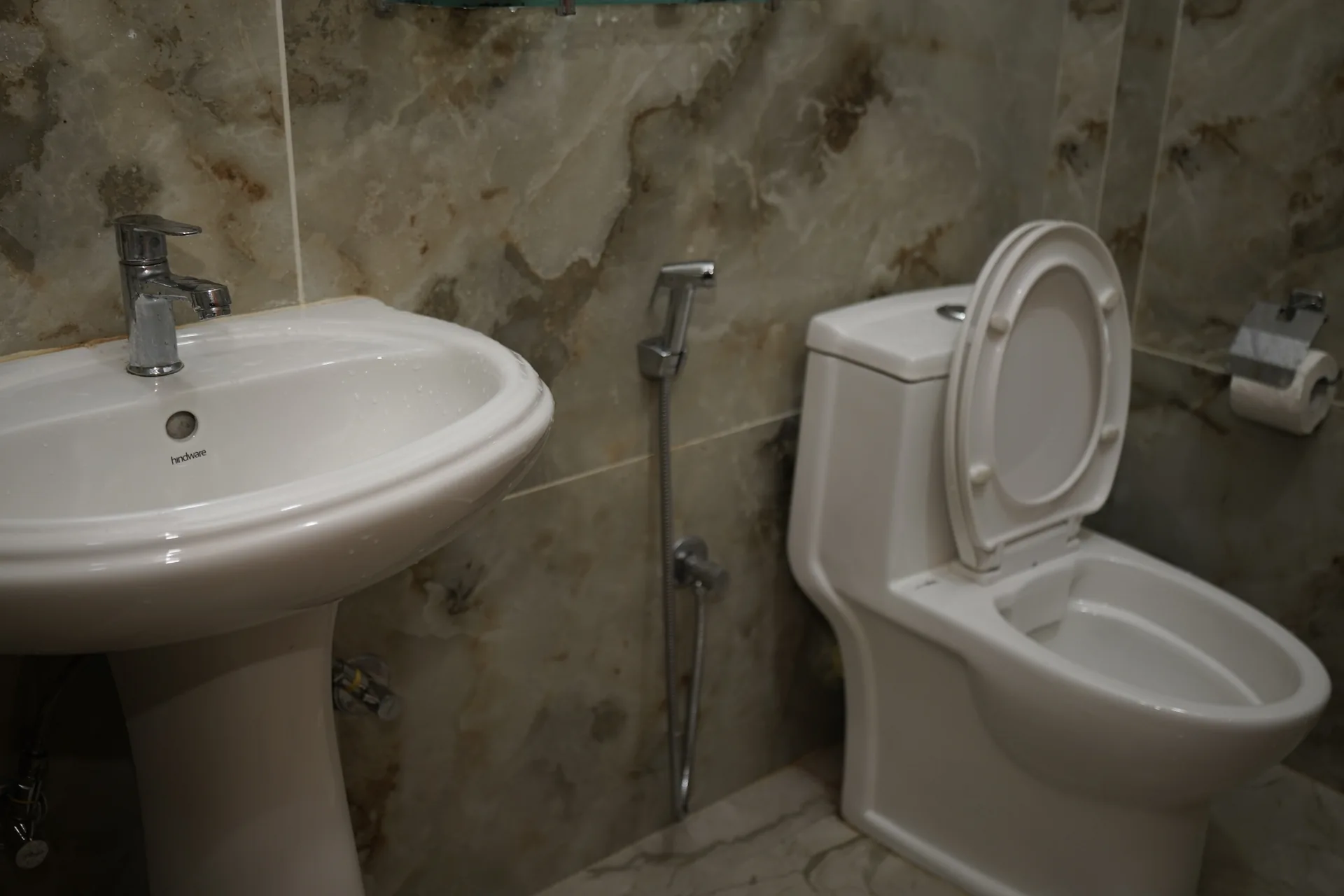Clean bathroom with marble tiles at Acorn Homestay