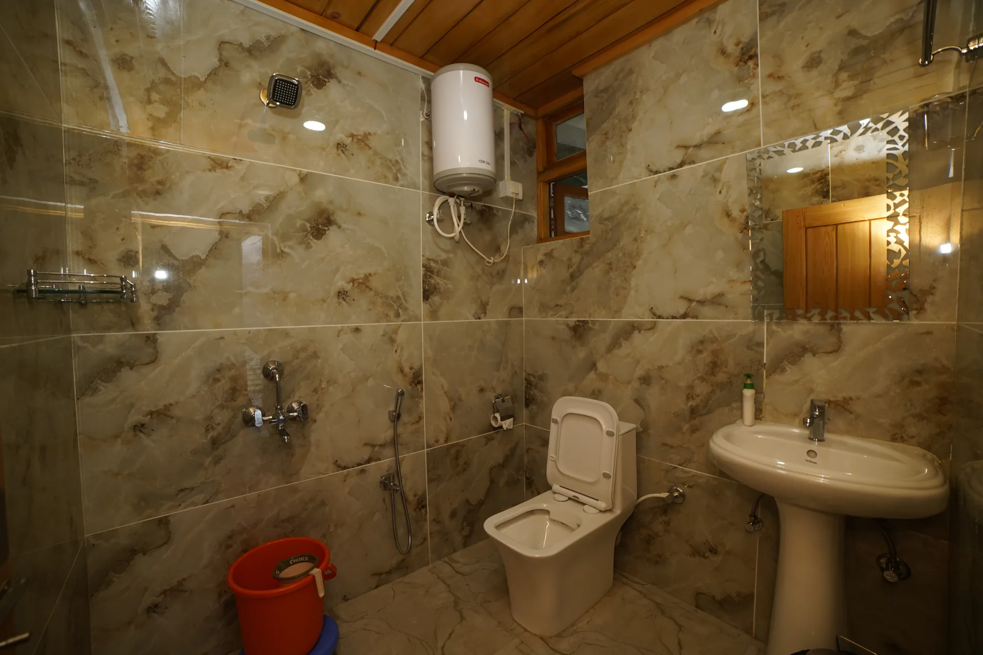 Bathroom with water heater and shower at Acorn Homestay