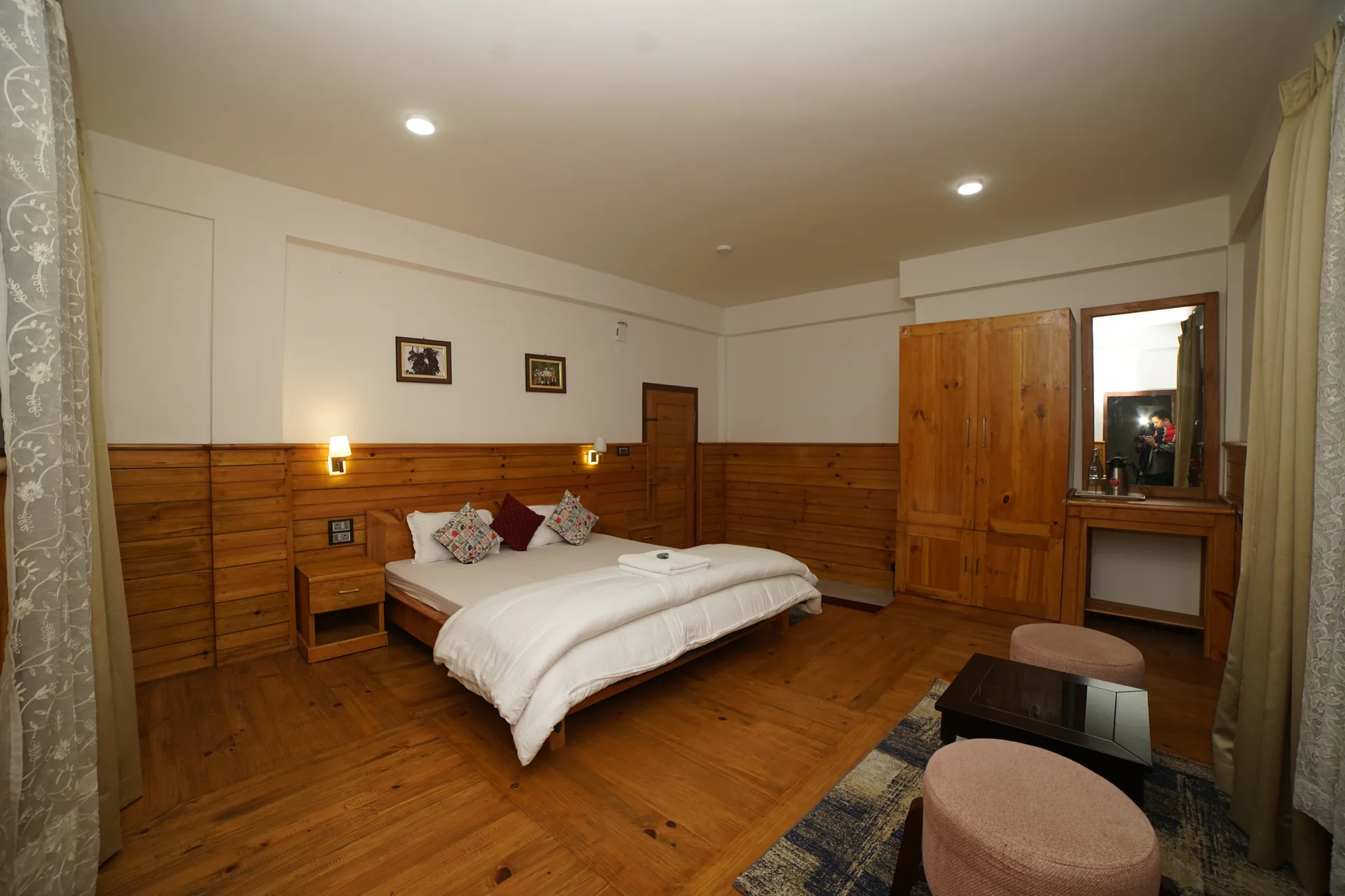 Deluxe room with dressing table at Acorn Homestay Shergaon