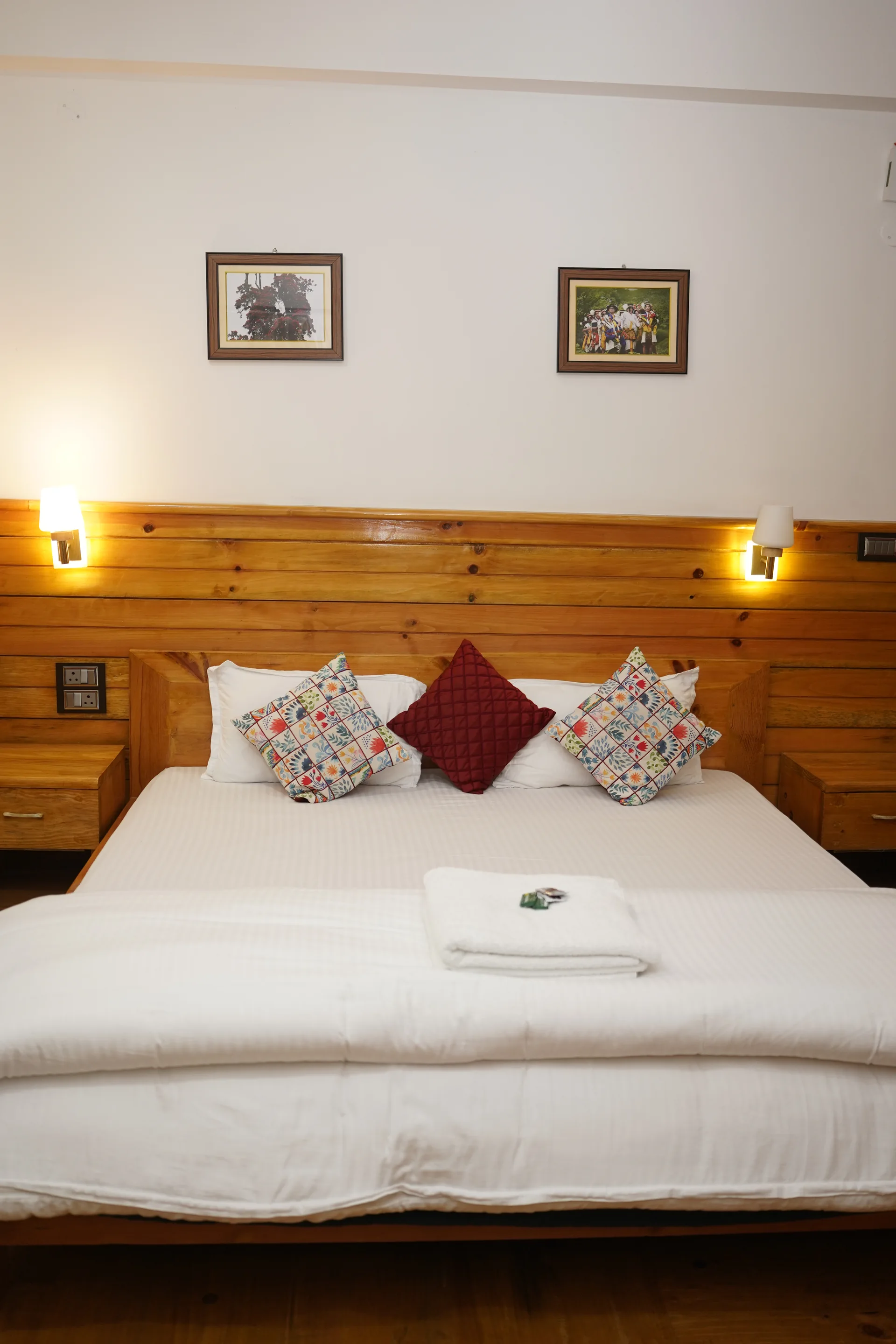 Bedroom overhead view with wall paintings at Acorn Homestay
