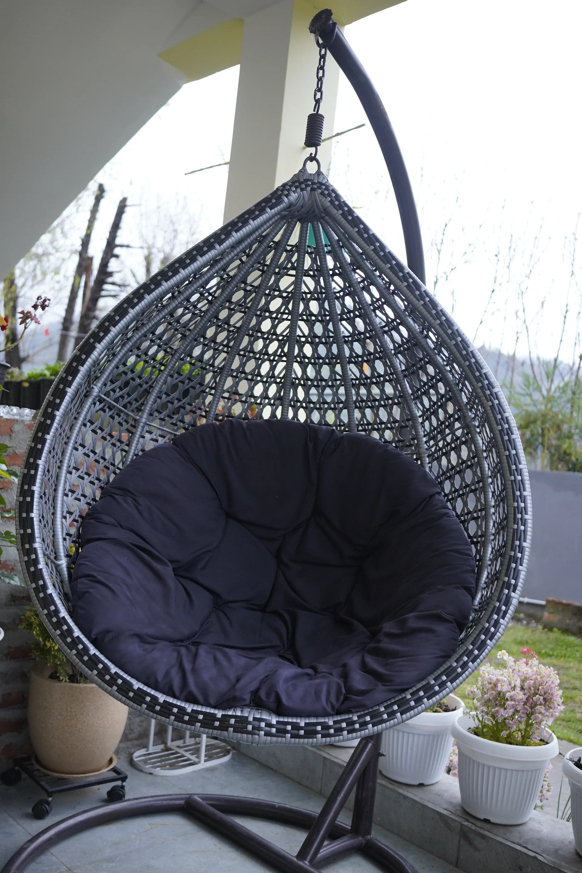 Outdoor hanging swing chair on terrace at Acorn Homestay