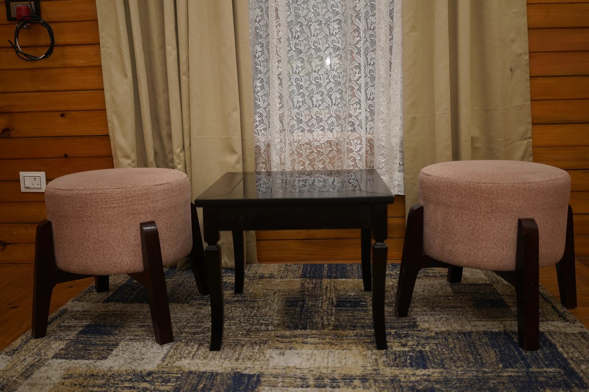 Cozy room seating nook with ottomans at Acorn Homestay