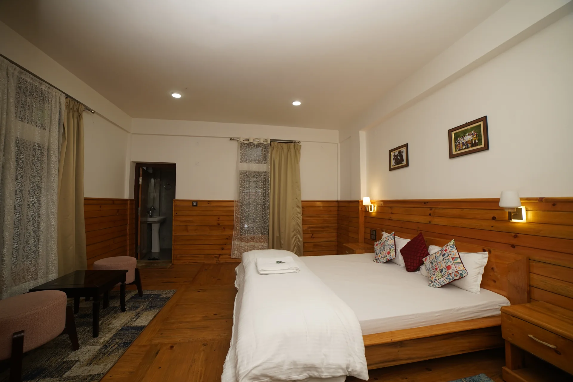 Spacious suite bedroom interior at Acorn Homestay Shergaon