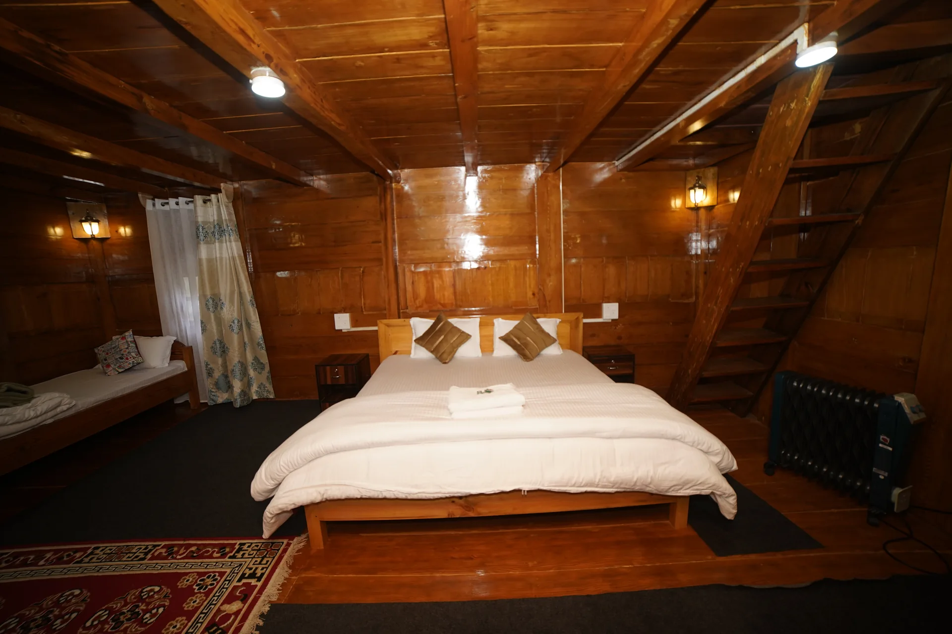 Traditional rustic wooden hut at Acorn Homestay Shergaon